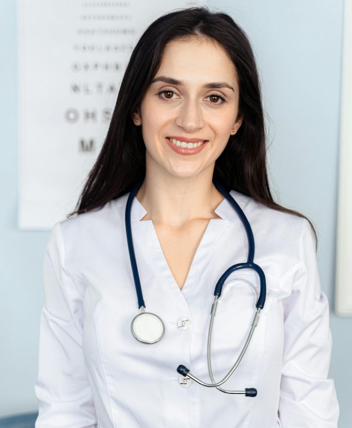 Smiling female doctor with stethoscope in a clinic setting. Warm, professional ambiance.